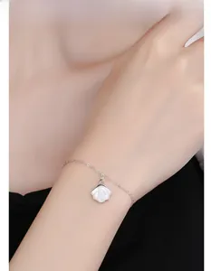 Close-up of 925 sterling silver bracelet with white mother-of-pearl ginkgo leaf charm