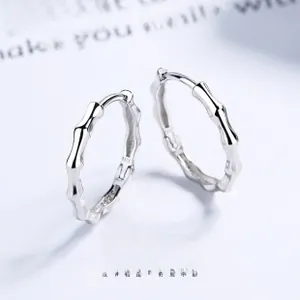 Detail of S925 sterling silver hoop earrings with a bamboo textured design and hallmark