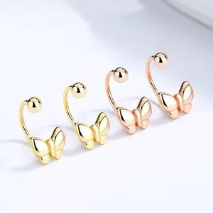 Detailed macro view of 925 sterling silver bow-shaped stud earrings in gold and rose gold
