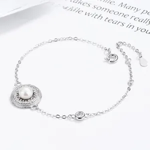 Detail of 925 silver bracelet featuring a white pearl and sparkling zircon accent