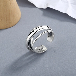 Detail of S925 sterling silver stamp on minimalist multi-layer cross winding ring