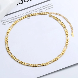 Detailed view of a polished golden Figaro chain necklace with lobster clasp closure