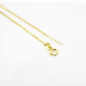 Close-up of golden square snake chain bracelet with spring clasp and pin connector