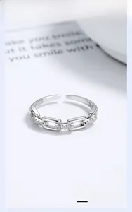 Macro detail of S925 sterling silver chain ring with pavé diamonds and hallmark stamp