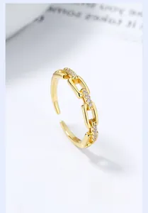 Macro shot of 925 sterling silver chain ring with pavé cubic zirconia in gold plating