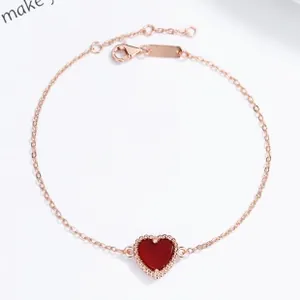Detail of S925 sterling silver heart bracelet with red gemstone and rose gold finish