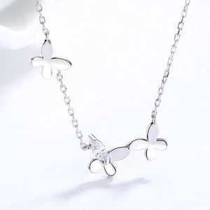 Close-up of 925 silver bow necklace with marquise-cut zircon stones on a gray background