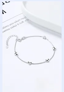 Macro shot of a 925 sterling silver box chain bracelet with small heart charms