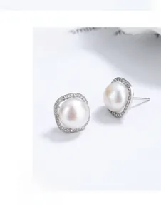Detailed close-up of S925 sterling silver pearl earrings with a gold square zircon frame