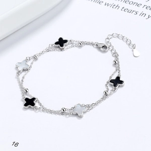 Detail of S925 sterling silver double-layer bracelet featuring four-leaf clover charms