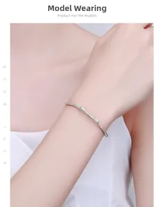 Close-up of sparkling bow-knot silver bracelet with zircons on a woman's wrist