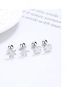 Detailed view of silver clover and maple leaf earrings with screw-back fasteners