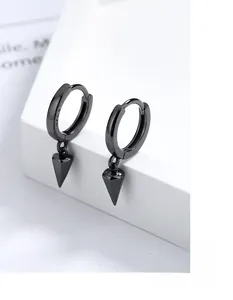 Macro detail of black conical S925 sterling silver earrings showing material engraving
