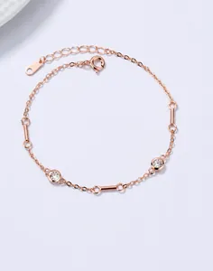 Detailed macro view of rose gold 925 silver bracelet with zircon and cylindrical charms