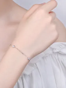 Close-up of minimalist S925 silver bracelet with circular zircons on woman's wrist