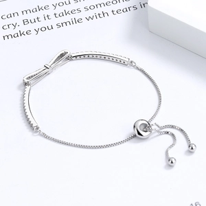Adjustable S925 sterling silver bow bracelet with sparkling cubic zirconia inlay