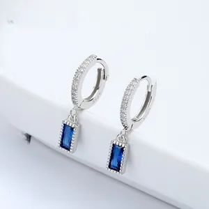 Close-up of S925 silver hoop earrings with white zircon and rectangular blue gemstone