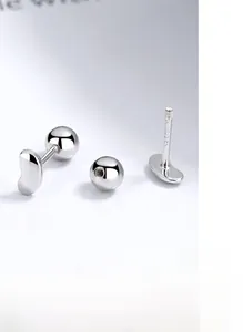 Vue détaillée des boucles d'oreilles en argent S925 avec design poli en forme de pois