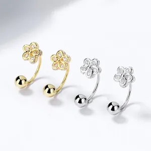 Detailed view of 925 silver daisy stud earrings in gold and silver with white zircon