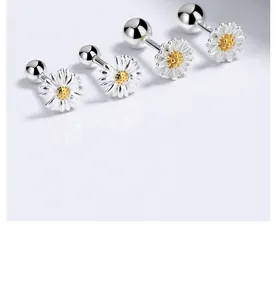 Macro shot of 925 sterling silver daisy earrings with yellow centers and screw backs