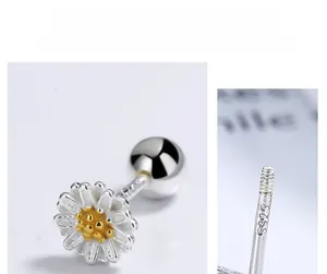 Macro shot of S925 sterling silver daisy earrings featuring detailed metal hallmark stamp