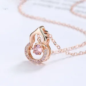 Macro view of rose gold gourd pendant necklace with pink stone and zircon inlay