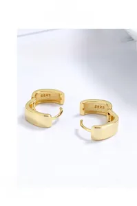 Close-up of golden geometric square earrings showing the S925 sterling silver stamp
