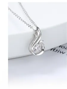 Macro shot of S925 silver phoenix pendant with a shimmering dancing stone setting