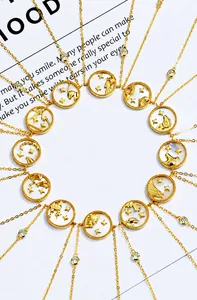 Detail of twelve zodiac necklaces with mother of pearl inlay and gold constellation charms