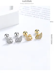 Detail of silver and gold swan stud earrings with screw ball backs and zircon inlay