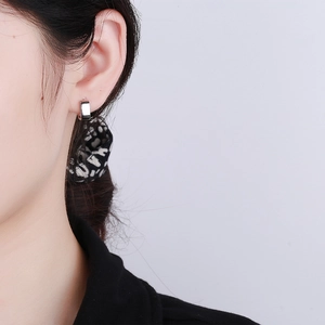 Minimalist 925 sterling silver geometric square hoop earrings worn by a model