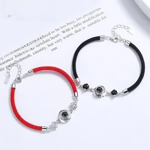 Detail of red and black S925 silver woven bracelets with circular projection stones