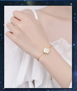 Detail of 925 sterling silver zodiac bracelet with white shell and gold star charm