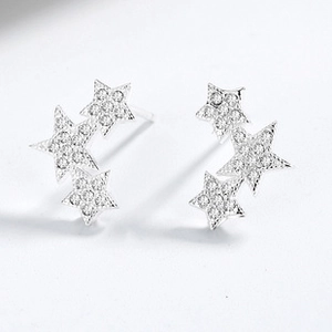 Macro view of sterling silver triple star earrings with sparkling cubic zirconia stones