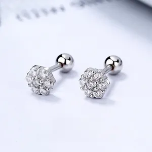 Macro shot of silver flower earrings with zircon stones and spherical screw back closure