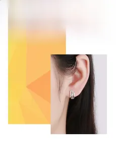 Detail of s925 silver irregular geometric earrings with micro-set cubic zirconia on model