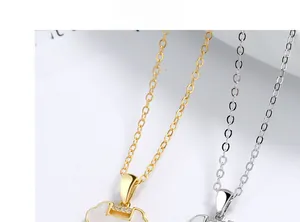 Detailed close-up of gold and silver Ruyi lock necklaces with white mother-of-pearl inlay