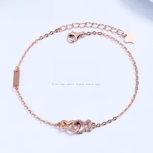 Detail of rose gold S925 silver bracelet with interlocking fish patterns and zircon pavé