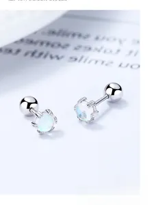 Macro shot of 925 silver screw back earrings with translucent moonstone opal gems
