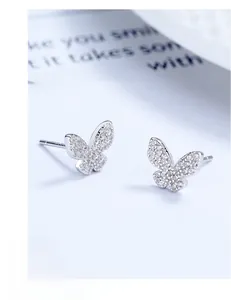 Macro shot of 925 silver butterfly earrings with micro-paved sparkling zirconia stones