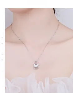 Detail of 925 silver Ruyi lock necklace with white shell inlay worn by a female model