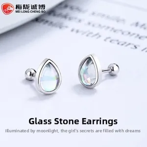 Macro detail of drop-shaped iridescent glass earrings with 925 silver screw backings