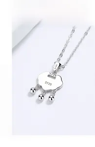 Macro detail of S925 sterling silver long-life lock pendant with engraved hallmarks