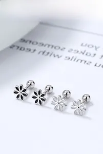 Macro shot of S925 silver daisy stud earrings with screw backs in black and white enamel