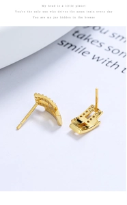 Macro detail of S925 sterling silver curved stud earrings with inlaid zircon stones