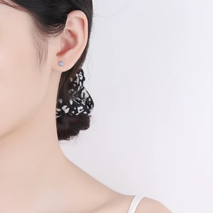 Minimalist s925 silver screw back moonstone stud earrings worn on a model's ear