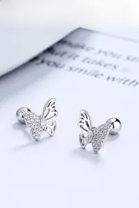 Macro shot of 925 sterling silver butterfly stud earring with screw back and sparkling zircon