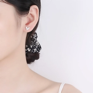 Elegant 925 silver butterfly stud earrings with sparkling cubic zirconia on female ear