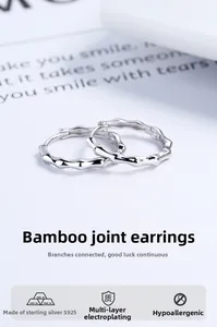 Detail shot of 925 sterling silver hoop earrings with a minimalist bamboo knot design