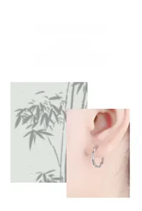 Detail of 925 sterling silver earrings featuring a minimalist bamboo joint hoop design